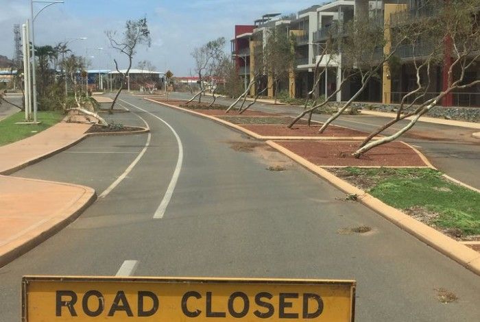 Road closed sign in front of damaged road