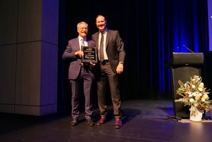 Peter Long being presented with the Honorary Freeman Award by Daniel Scott