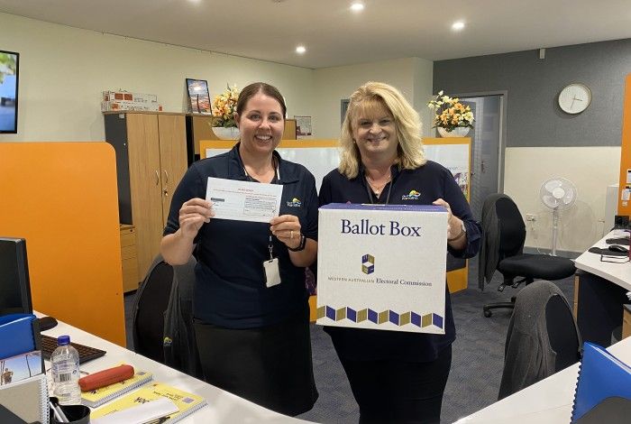 two City workers with a vote pack and ballot box