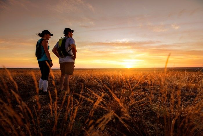 two hikers looking at the sunset in millstream